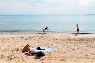 Guys are filming some girls on the beach